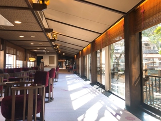 【ロビー】桂川に架かる橋の上で、窓いっぱいに広がる景色を眺めながらチェックイン